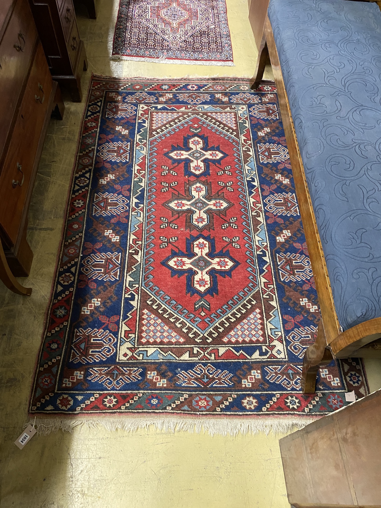 A Caucasian style red ground rug, 186 x 120cm